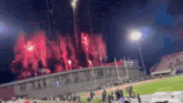 a stadium with fireworks going off in the sky
