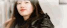 a close up of a woman 's face with a blurred background .
