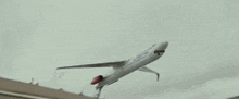 a white airplane is flying through the air