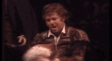 a blurry picture of a man holding a woman 's hand