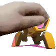 a close up of a person 's hand holding a toy .