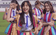 a group of girls wearing colorful outfits and ties