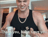 a man is holding a can of soda and a glass with the words thank you babe love you on the bottom
