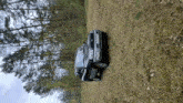 a car is parked in the middle of a forest .