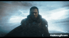 a man is standing in front of a cloudy sky with lightning coming out of it .