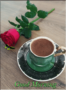 a cup of coffee sits on a saucer next to a rose with the words good morning written on the bottom