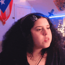 a woman with curly hair wearing headphones and a headband with 00 on it