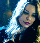 a close up of a woman 's face with red lipstick