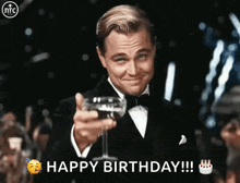 a man in a tuxedo is toasting with a glass of wine and says happy birthday