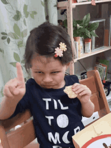 a little girl wearing a shirt that says til to mcp