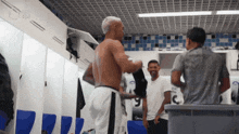 a shirtless man in a locker room with the number 9