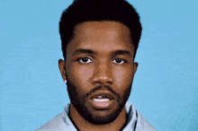 a man with a beard is wearing a pair of earrings
