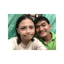 a man and a woman are posing for a picture and smiling