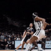 a basketball game is being played in front of a crowd
