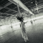 a woman in a white dress is dancing in an empty parking lot