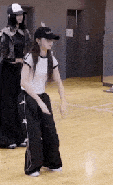 a woman is dancing on a wooden floor in a dance studio .