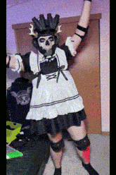 a person in a maid dress with a skull on their head .