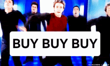 a group of men are dancing in front of a sign that says " buy buy buy "