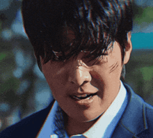 a close up of a man 's face with scratches on it