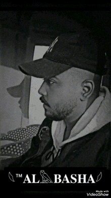 a black and white photo of a man wearing a new york hat