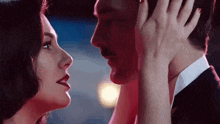 a man and a woman are touching their faces