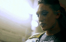 a close up of a woman 's face with a black shirt