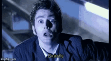 a man in a suit and tie is saying exactly in a gif .