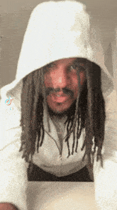 a man with dreadlocks wearing a white hoodie with tiktok written on it