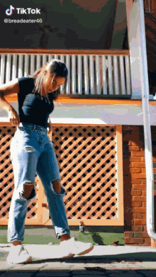 a woman is standing on a skateboard in front of a brick building with the hashtag tiktok at the top