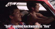 two men singing in a car with the words " evil spelled backwards is " live "