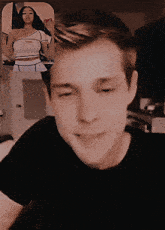 a man in a black shirt is smiling in front of a woman in a white top