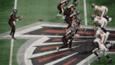 a football game is being played on a field with the falcons logo in the background