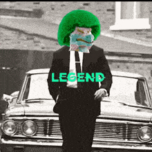 a man in a suit and tie is standing in front of a car with legend written on it