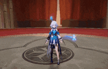 a girl in a blue dress is standing in a circle in a room