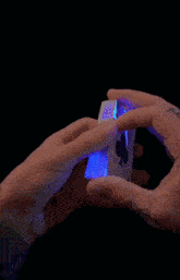 a person with a tattoo on their finger is holding a stack of playing cards with the letters j k and q on them