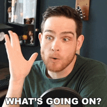 a man in a green shirt says " what 's going on " in front of a microphone