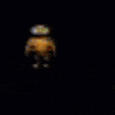 a blurry picture of a cartoon character standing in front of a blue and purple background .