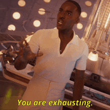 a man in a white shirt says you are exhausting in yellow letters