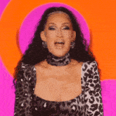 a woman in a leopard print dress has the word none written on her chest