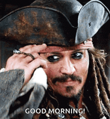 a man with dreadlocks is wearing a pirate hat and says " good morning "