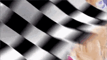 a black and white checkered background with a person in the background