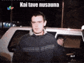 a man is standing in front of a car with the words kai tave nu sauna written on the bottom