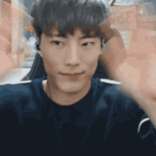 a close up of a young man wearing headphones and a black sweater .