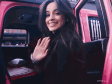 a woman in a pink car with gifcamilas written on the bottom right