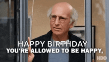 a bald man with glasses is holding a piece of paper and says `` happy birthday you 're allowed to be happy , ''