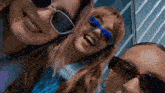 three women wearing sunglasses are smiling and looking at the camera