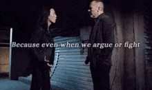 a man and a woman are talking to each other in a dark room .
