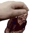 a pixel art of a hand holding a zombie on its head .