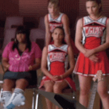 a group of cheerleaders in red uniforms with the word girls on the front