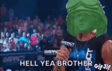 a man wearing a green helmet and goggles is holding a microphone and says hell yea brother